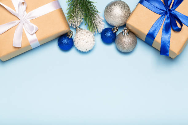 istock Christmas blue background with decorations, gift box and fir branches top view 1277538784