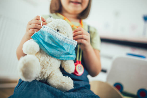 istock Child playing doctor with soft toy. 1277539586