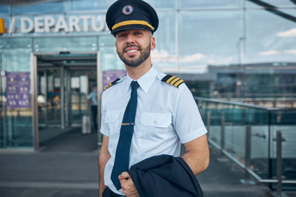 istock Handsome male pilot standing on the street 1277540547