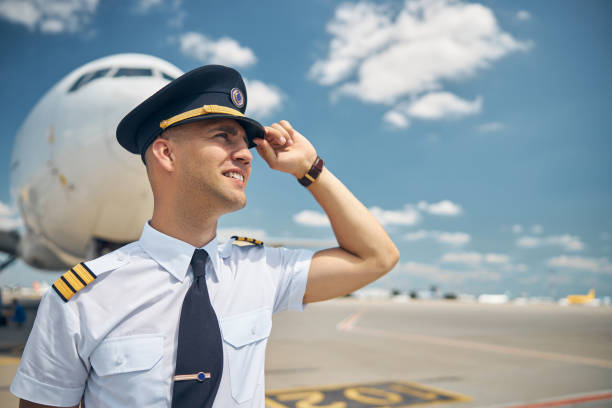 istock Handsome male pilot standing outdoors at airport 1277540620