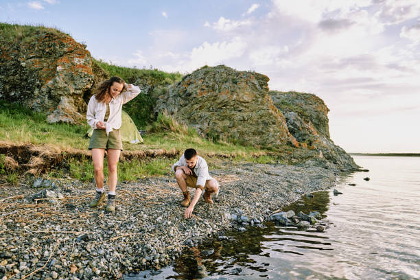 istock Couple choosing stones on waterside 1277541636