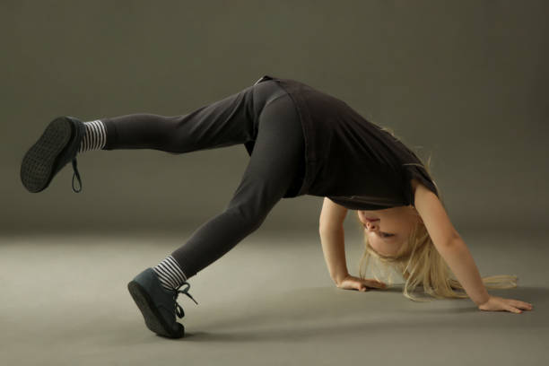 istock Adorable little kid practising break dance, studio shot on grey background 1277543338