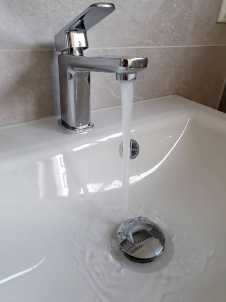istock Tile water from the faucet into a sink 1277544652