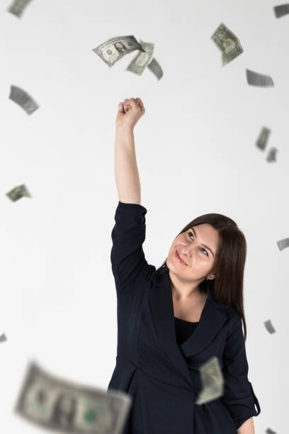 istock Rejoicing. Woman in blue and dollars. 1277546115
