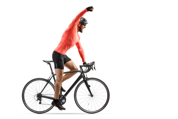 istock Male cyclist riding a road bicycle and gesturing win with hand 1277546946