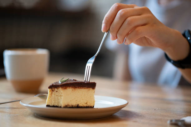 istock Midsection Of Woman Eating Dessert At Table 1277547064