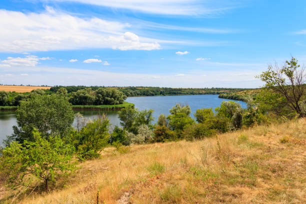 istock Summer landscape with beautiful river, green trees and blue sky 1277548375