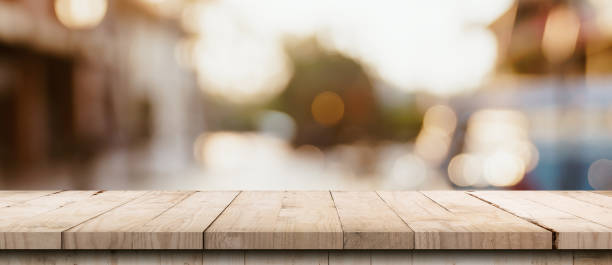 istock Empty wood table and blurred light table in shopping mall with bokeh background. product display template. 1277550039
