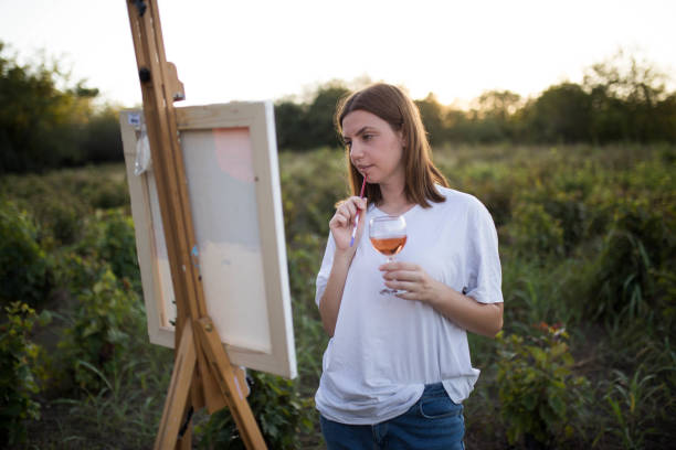 istock Creative woman painting in nature 1277550079
