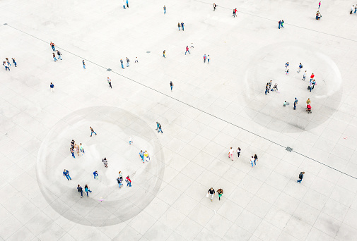 Aerial view of people walking in a bubble for COVID-19 protection.