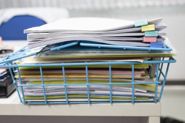 istock file folder and Stack of business report paper file on the table in a work office, concept document in work office 1277555948
