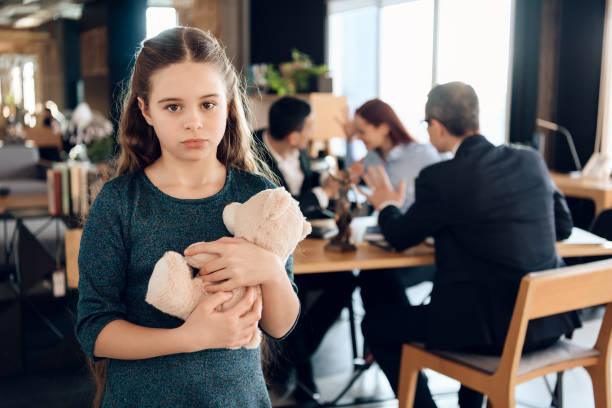 Sad girl stands with a bear in the office. stock photo