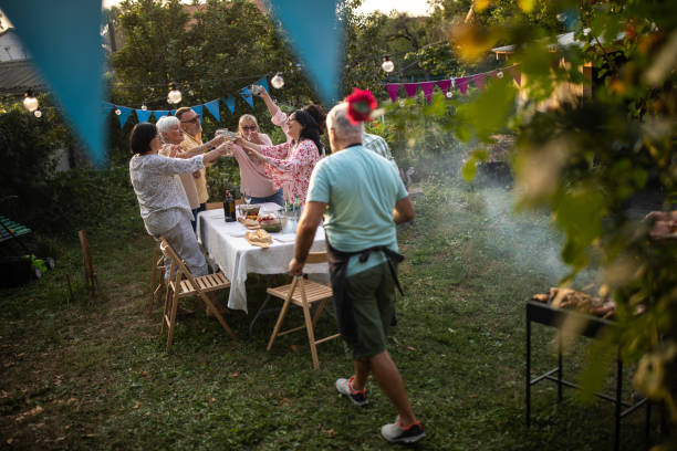 istock Old friends enjoying quality time together on party at backyard 1277558176