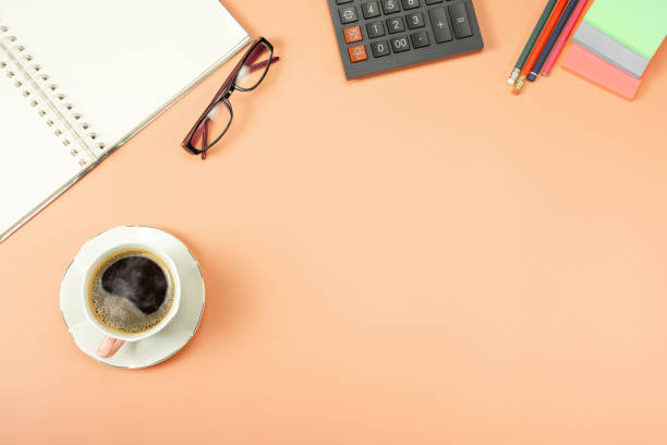 stylish table desk, workspace. workplace in office with modern desk. top view from above of calculator with notepad and coffee. flat lay with blank copy space. - down view imagens e fotografias de stock