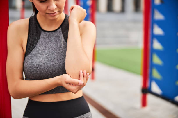 istock Young woman hurt elbow during workout outdoors 1277565354