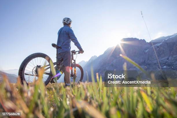 Mountain Ebiker Rides Through Alpine Meadow At Sunrise Stock Photo - Download Image Now