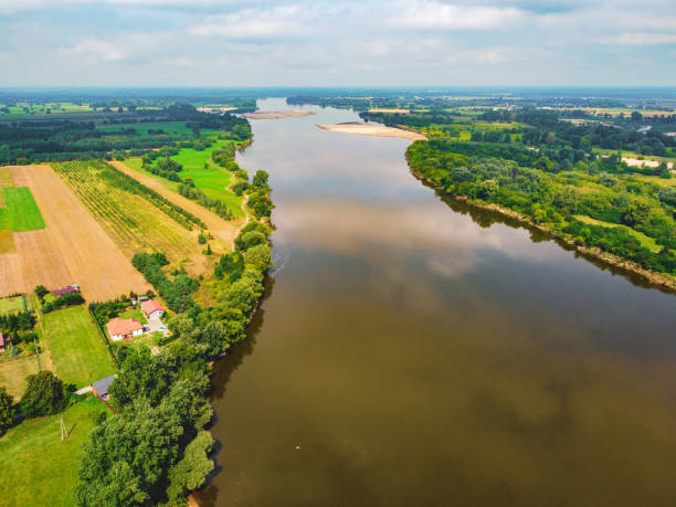 Large river flows through meadows and fields. Drone, aerial view stock photo
