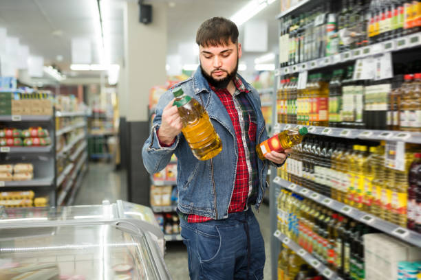 istock Focused bearded man looking for vegetable oil 1277569688