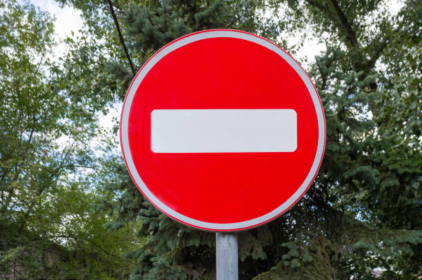 Red brick road sign on the road in summer