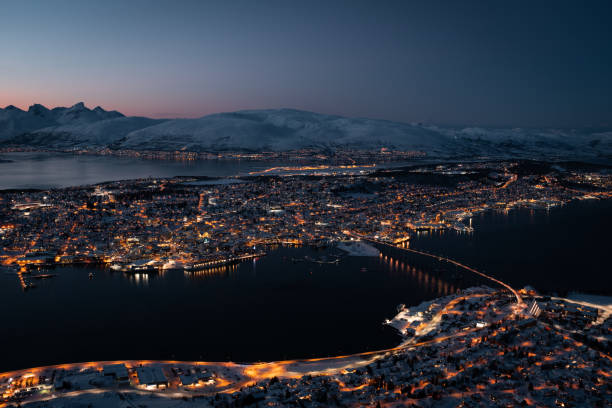 Tromsø Cityscape Glowing at Night Tromsø Norway cityscape glowing at night. Bird's eye view aerial. tromso stock pictures, royalty-free photos & images