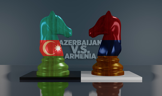 Azerbaijan versus Armenia war concept. Azerbaijan and Armenia flags on wooden chess knights. A small \