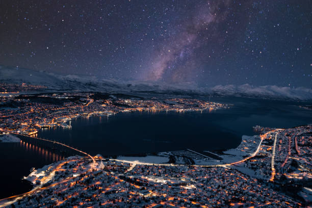 Photo of Illuminated Tromsø Nighttime Cityscape with Stars in Sky