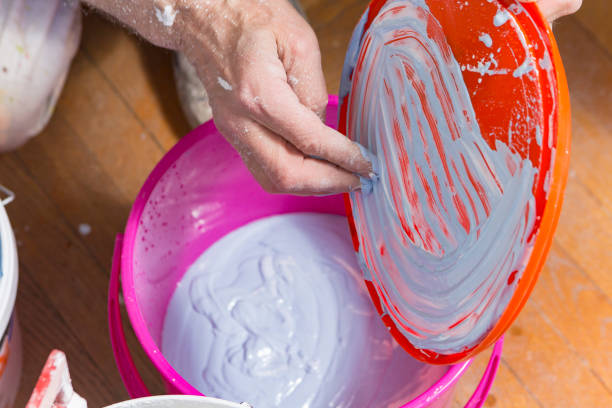 istock Senior old man painter's hand preparing a wall painting 1277576293