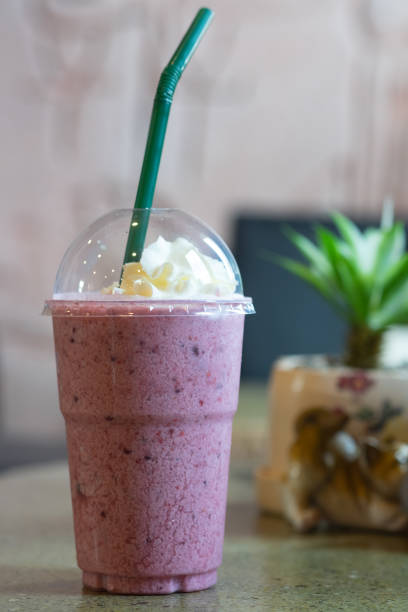 istock Blueberry smoothie yoghurt with whipped cream in plastic glass 1277576366