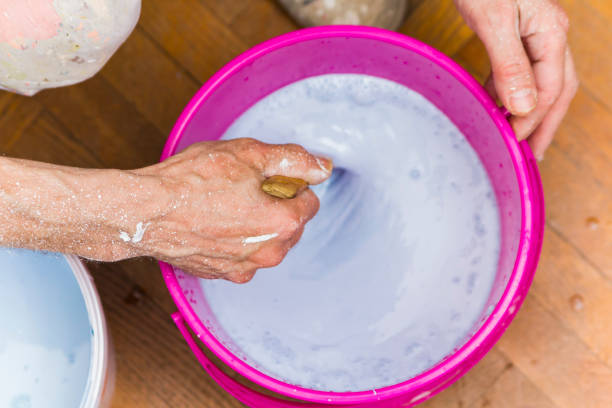 istock Senior old man painter's hand preparing a wall painting 1277576550