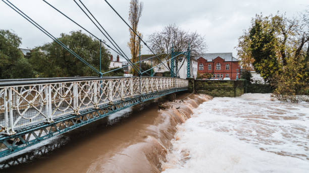 istock Flood water surging past an old Victorian bridge in a British town 1277577332