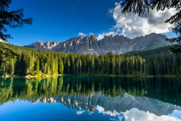 Carezza lake, Mount Latemar, Bolzano province, South tyrol, Italy. Landscape of Lake Carezza or Karersee and Dolomites in background, Nova Levante, Bolzano, Italy.