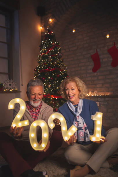 istock Senior couple holding illuminated numbers 2021 1277577722
