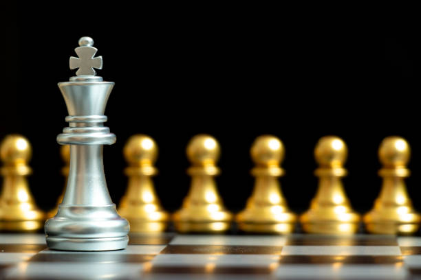 istock Silver king chess piece face with gold team on black background (Concept for company strategy, business decision and encounter the problem) 1277578123