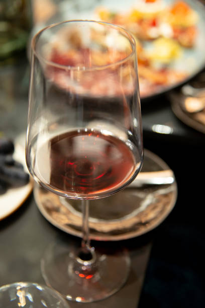 istock close up of red wine glass on table 1277579333