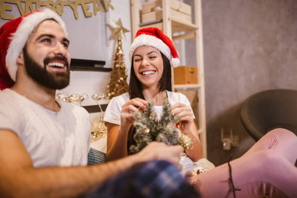 istock Young couple decorates a Christmas tree at home 1277579493