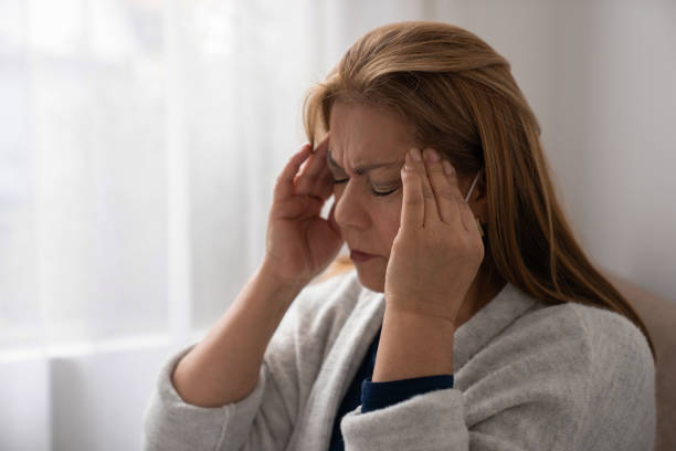 istock Woman at home having a headache and looking stressed 1277582551