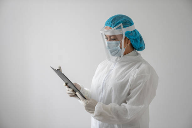 istock Doctor wearing PPE while working during the COVID-19 pandemic and reading chart on a clipboard 1277582568
