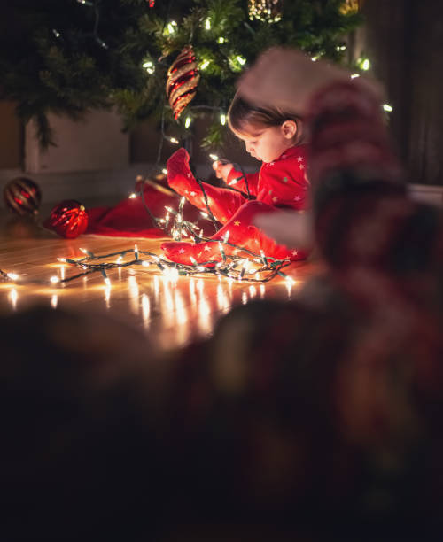 istock Brother & Sister Decorate Christmas Tree 1277582846