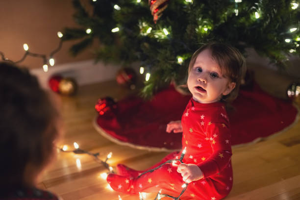 istock Brother & Sister Decorate Christmas Tree 1277582909