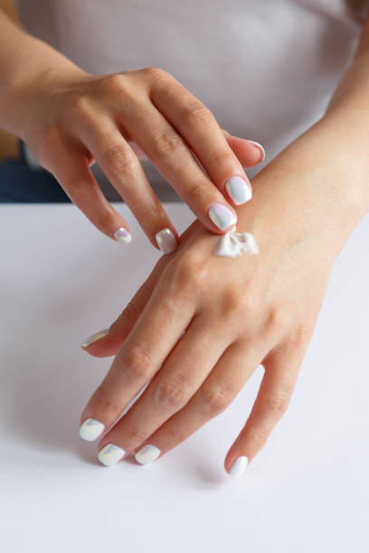 istock Woman smearing soft moisturizer on hands skin 1277583829