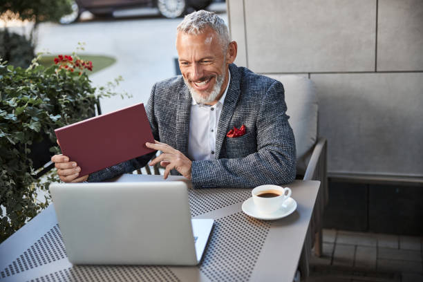 istock Friendly aged gentleman holding a dark-red box 1277587833