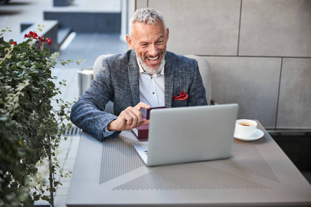 istock Active senior citizen demonstrating a card via video-call 1277587860