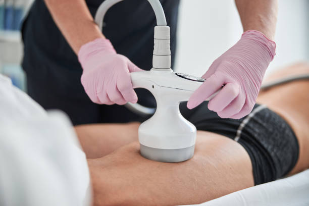 istock Beautician performing a non-invasive procedure on patient legs 1277588051