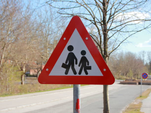 istock Triangle Warning Road Sign with School Children 1277590984