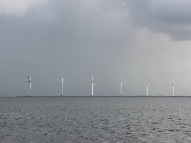 istock Ocean Sea Windmill in Line at Distance 1277591222