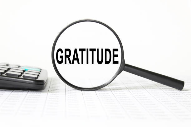 istock words GRATITUDE in a magnifying glass on a white background. business concept 1277591316