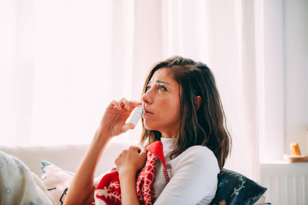 istock Sick Woman Using Nasal Spray 1277591661