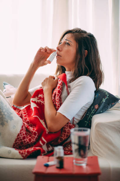 istock Sick Woman Using Nasal Spray 1277592778