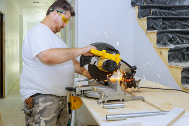 Worker a cutting of a metal pipe with splashes of sparks Worker a cutting of a metal pipe with splashes of a saw, sparks fly miter saw stock pictures, royalty-free photos & images