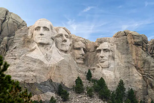 Mount Rushmore National Monument in South Dakota with carvings of George Washington, Thomas Jefferson, Theodore Rosevelt, and Abraham Lincoln a symbol of freedom and patriotism.
